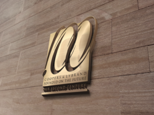 Centennial logo design Professional services branding Coopers & Lybrand centennial Commemorative book design Corporate anniversary branding PwC brand history Strategic messaging Market re-engagement Legacy and innovation branding AgencyBEL branding project