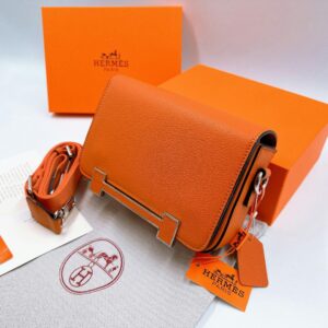 Hermes Luxurious Leather Purse Hermès Birkin bag displayed in luxury boutique, exemplifying exclusive branding strategy.